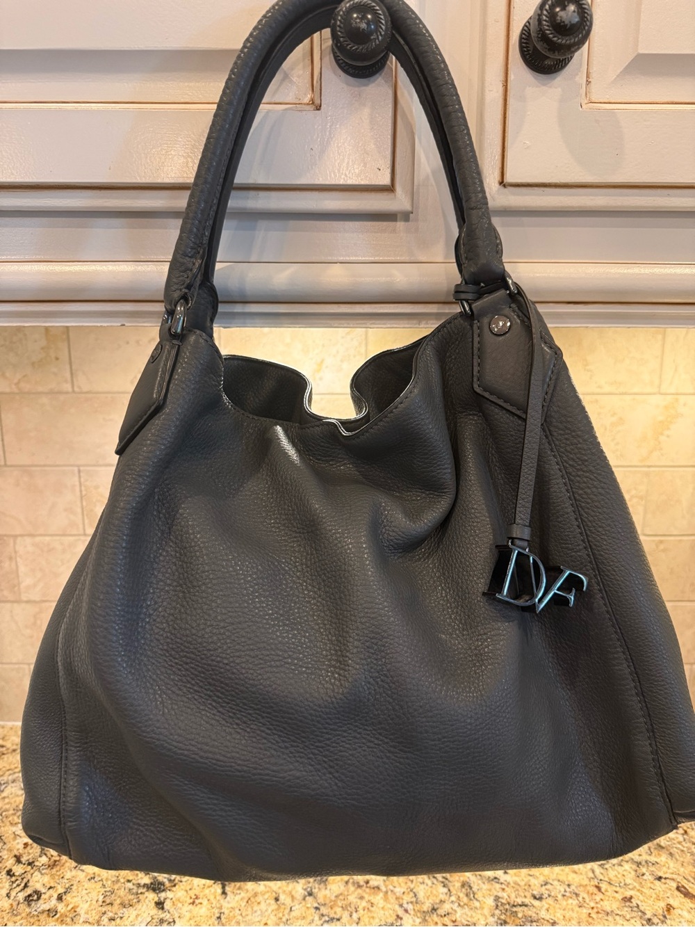 Diane Von Furstenberg grey Pebbled Leather Hobo shoulder bag with DVF Charm.